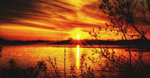 Scenic view of lake against romantic sky at sunset