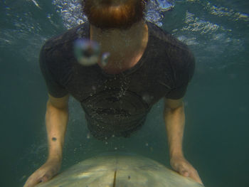 Close-up of man surfing undersea