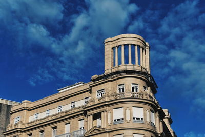 Low angle view of historic building against blue sky