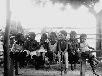 Group of people sitting against the sky