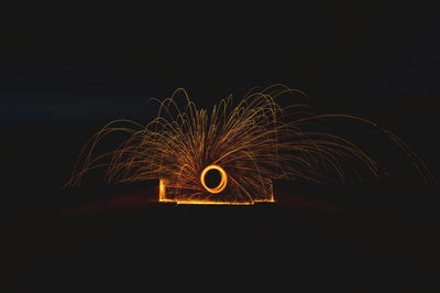 Low angle view of fireworks against sky at night