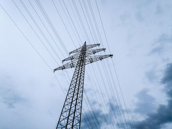 Low angle view of electricity pylon against sky