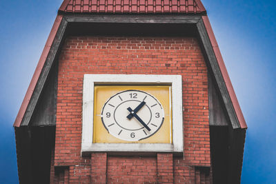 Low angle view of clock on wall