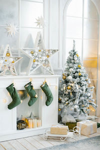 Stylish christmas decor of the living room in gold and silver tones. a large beautifully decorated