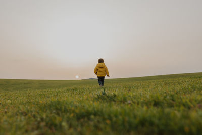 Child walking on grass