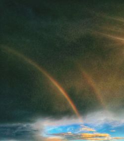 Low angle view of rainbow against sky