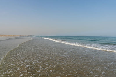 Scenic view of beach against clear sky