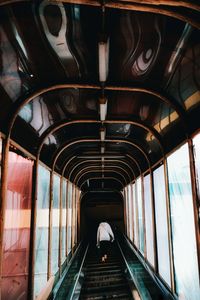 Rear view of man on escalator