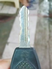 Close-up of hand holding metal