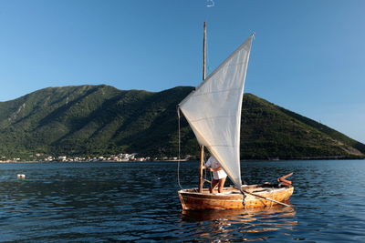 Man standing on boat in lake