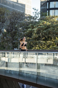 Woman jogging on footbridge