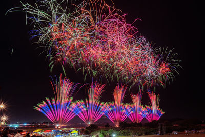 Low angle view of firework display at night