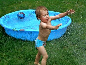 Full length of shirtless boy in water