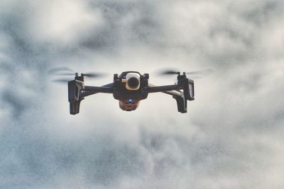 Drone flying against sky