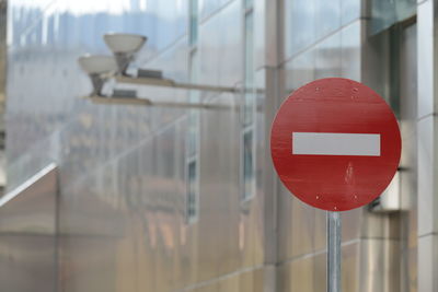 Close-up of road sign against built structure