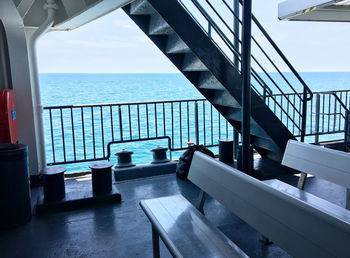 Scenic view of swimming pool by sea against sky seen through window