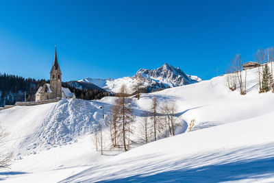 Scenic view of snowcapped mountains against clear blue sky