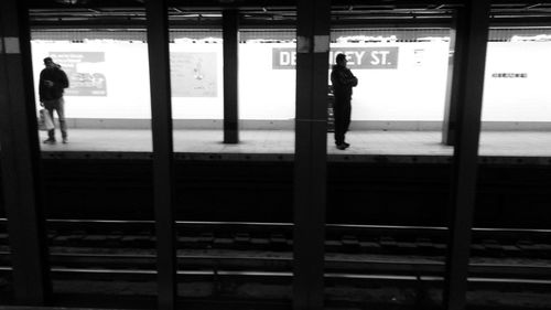 Woman standing on railroad track