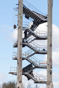 Low angle view of crane against sky