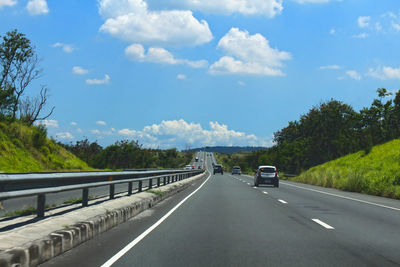 Cars on road against sky