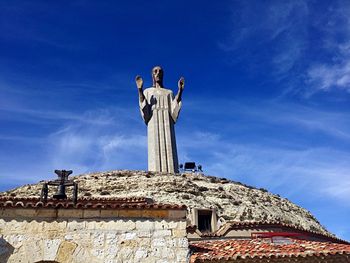 Low angle view of statue against blue sky