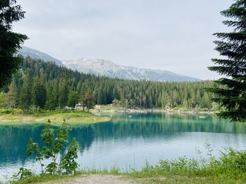 Scenic view of lake and mountains against sky