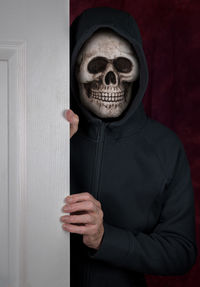 Portrait of man wearing skull mask