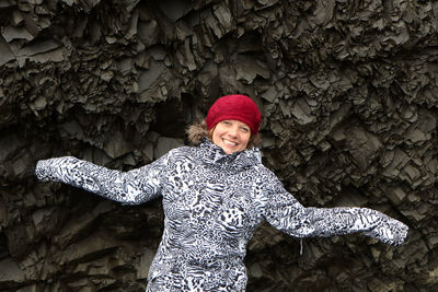 Portrait of smiling woman standing in snow