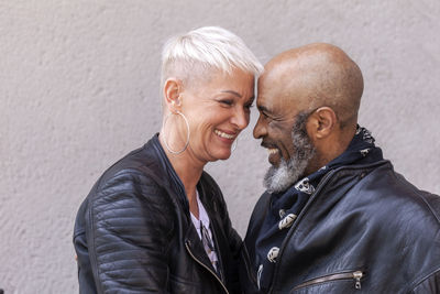Affectionate mature biker couple in leather clothes