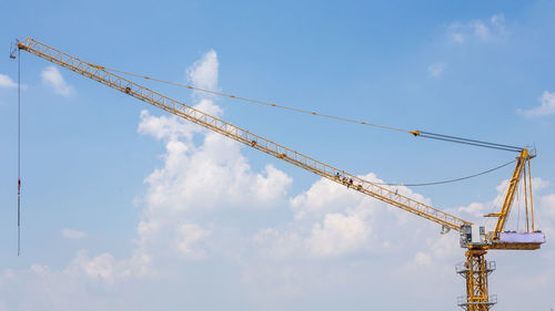 Low angle view of crane against sky