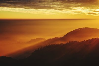 Scenic view of dramatic sky during sunset