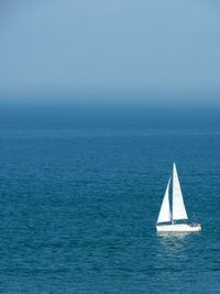 Boat sailing on sea against sky