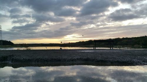 Scenic view of lake against cloudy sky