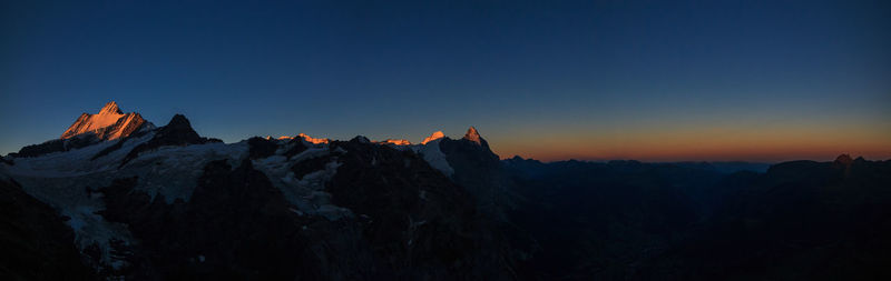 Panoramic view of mountains against sky during sunrise