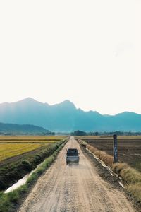 Adventurous image with a car in the middle in a nature landscape.