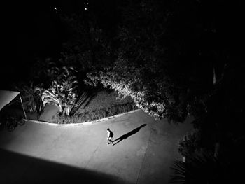High angle view of man skateboarding on street at night
