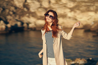 Woman wearing sunglasses standing outdoors