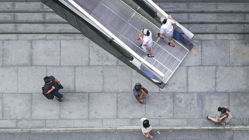 High angle view of people walking on staircase