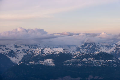 Scenic view of snowcapped mountains against sky during sunset