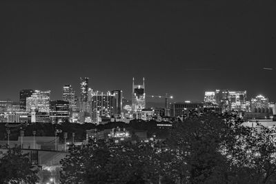 High angle view of illuminated buildings against clear sky at night