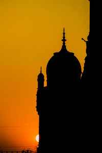 Silhouette temple against sky during sunset