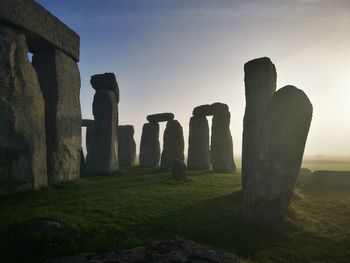 Stone structure on field against sky