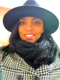 Portrait of smiling young woman in hat