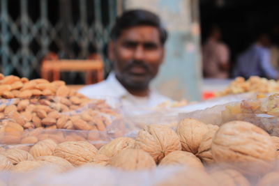 Man selling dried fruits at market stall