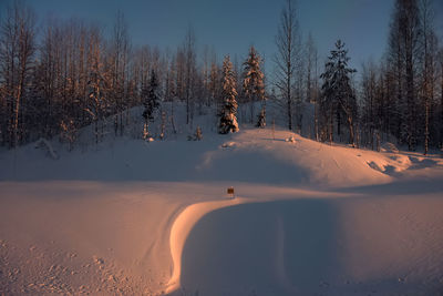 Scenic view of snow covered land against sky