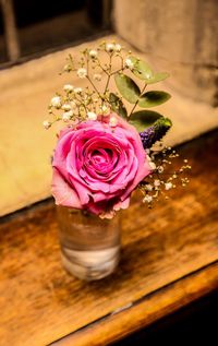 Close-up of pink rose on table