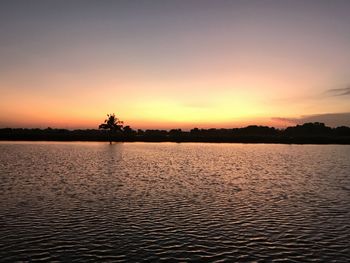 Scenic view of lake against sky during sunset