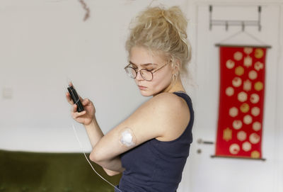 Young woman using insulin pump