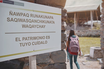 Group of tourists listening the guide explanation about wari archaeological complex, ayacucho. peru