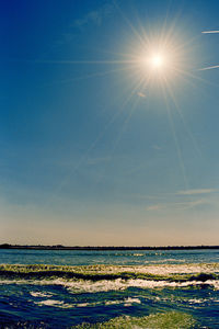 Scenic view of sea against clear sky at sunset
